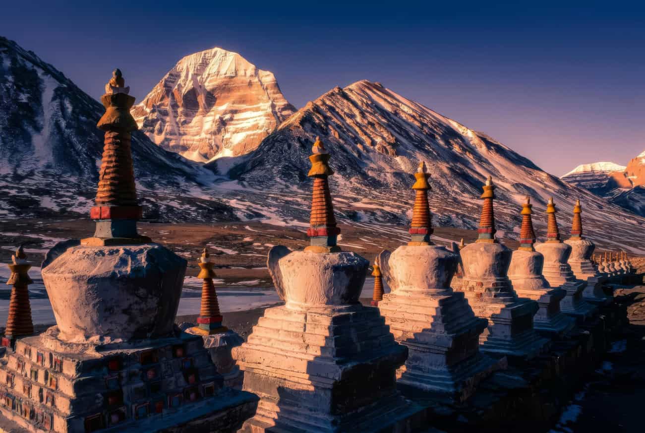 White chortens before a golden Kailash at dusk